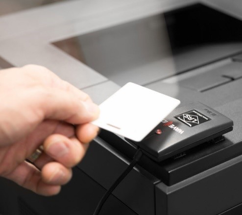 Hand tapping proximity card to retrieve print jobs
